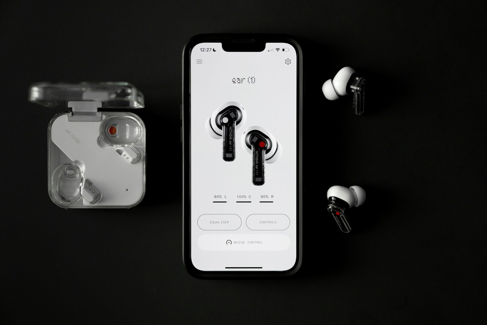 A pair of headphones sitting next to an iPhone